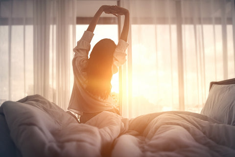 Woman feeling well-rested in the morning after a night with Cernosleep and Eight Sleep